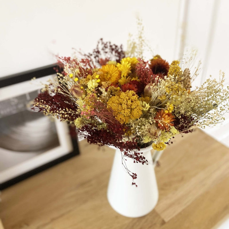 bouquet de fleurs séchées dans les tons jaune orange et bordeaux